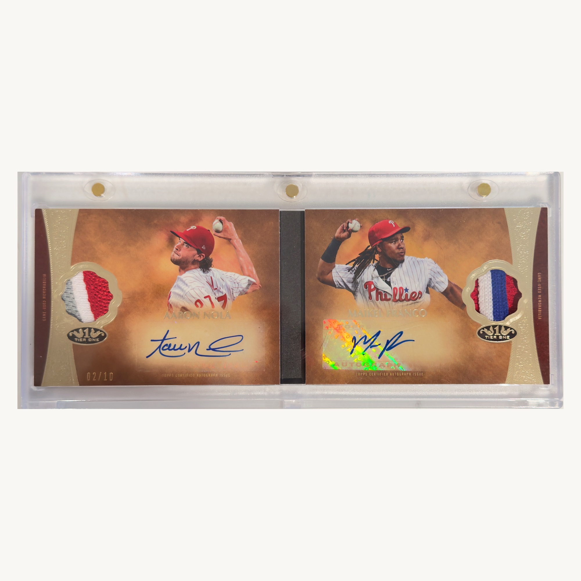 Open Topps Tier One dual autograph relic booklet card featuring Aaron Nola and Maikel Franco